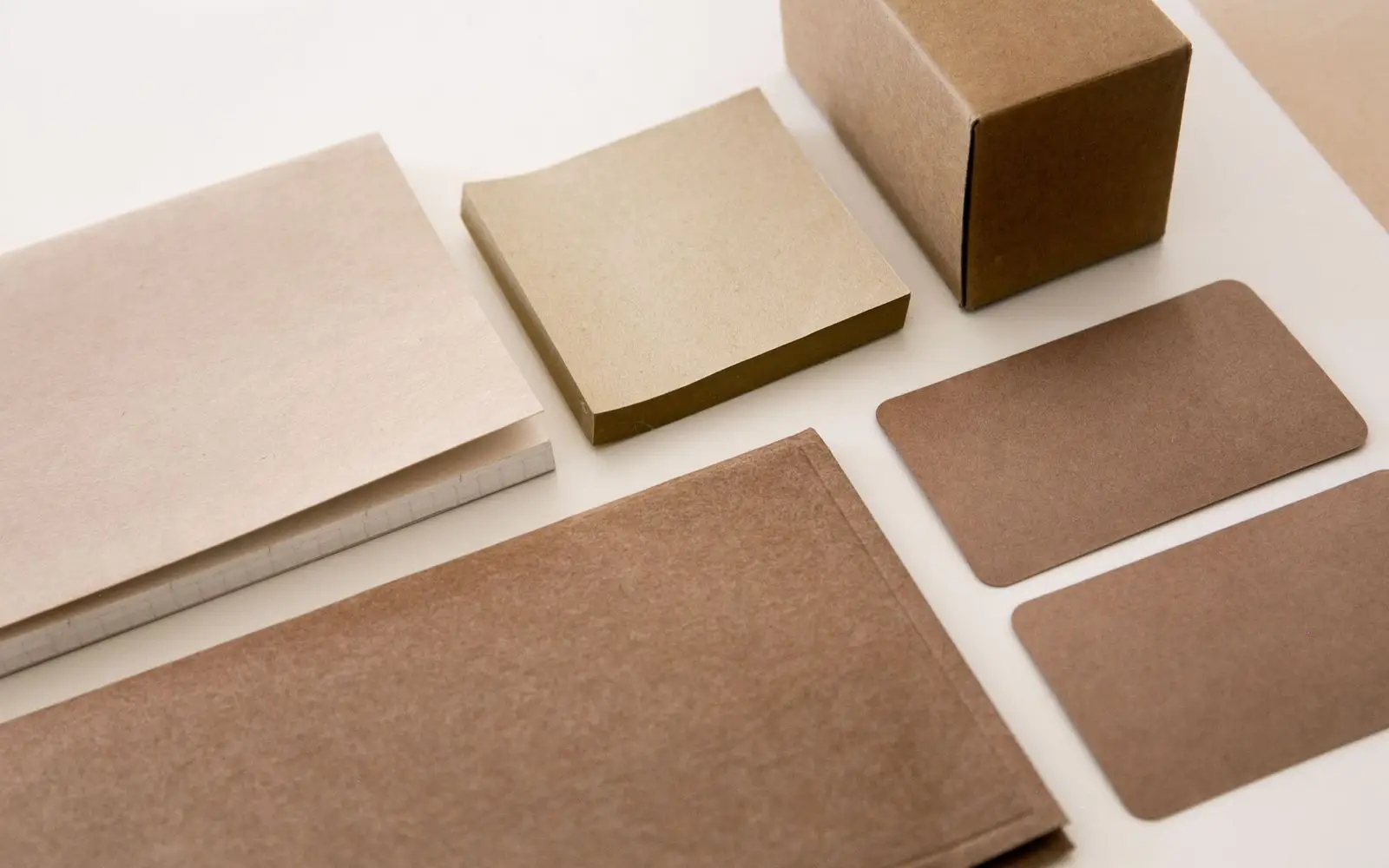 Kraft paper, card samples and a small box in shades of brown